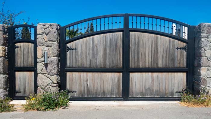 Wooden door with brick stone wall.Architecture background - aged wooden door.