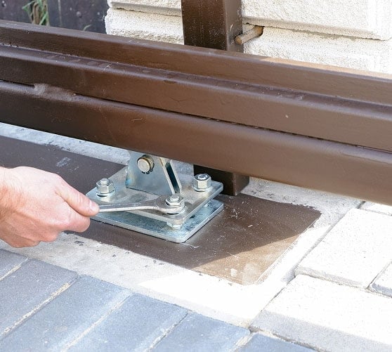 Worker installing a gate